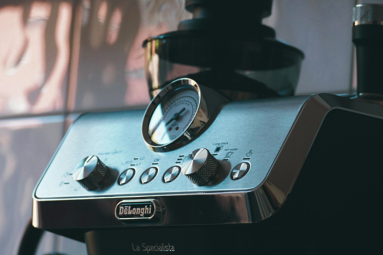 a close up of a coffee maker with a clock on it